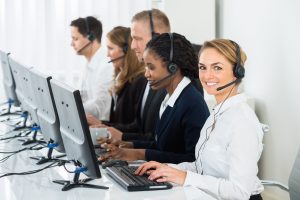 five employees ready to take client calls for the day