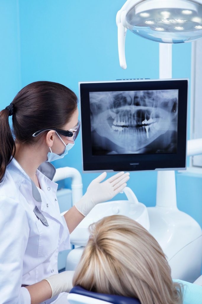 dentist showing teeth xray to patient