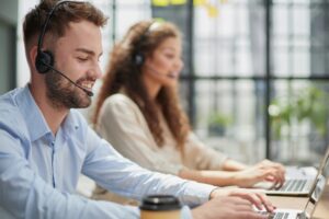 Customer,Service,Representative,With,Colleague,Working,In,Office